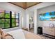 Bedroom with king-size bed, en-suite bathroom, and a TV at 741 Jacaranda Rd, Anna Maria, FL 34216