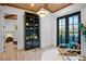 Home office with built-in shelving and balcony access at 741 Jacaranda Rd, Anna Maria, FL 34216