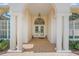 Elegant entryway with arched columns and double doors at 8843 Wild Dunes Dr, Sarasota, FL 34241