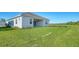 Landscaped backyard with grassy area and privacy fence at 10142 Crystal Isles Cir, Sarasota, FL 34241