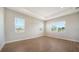 Bright bedroom with wood-look floors and multiple windows at 10142 Crystal Isles Cir, Sarasota, FL 34241
