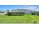 Landscaped backyard with lush lawn and hedge at 10300 Lake George Ave, Sarasota, FL 34241