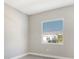 Simple bedroom with tile flooring and one window at 10300 Lake George Ave, Sarasota, FL 34241
