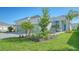 House exterior showcasing landscaping and a two-car garage at 10300 Lake George Ave, Sarasota, FL 34241