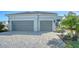 Two-car garage with herringbone driveway and landscaping at 10300 Lake George Ave, Sarasota, FL 34241