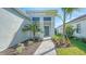 Welcoming front entry with a walkway and tropical landscaping at 10300 Lake George Ave, Sarasota, FL 34241