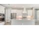 Bright kitchen featuring white cabinets and a large island at 10300 Lake George Ave, Sarasota, FL 34241