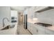 Sleek kitchen with stainless steel appliances and white cabinets at 10300 Lake George Ave, Sarasota, FL 34241
