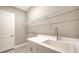 Laundry room with sink, shelving and tile floor at 10300 Lake George Ave, Sarasota, FL 34241