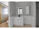 Clean bathroom with single sink vanity, shower, and storage at 10307 Sandpiper W Rd, Bradenton, FL 34209