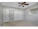 Spacious bedroom with ceiling fan, carpet, and double closets at 10307 Sandpiper W Rd, Bradenton, FL 34209