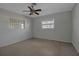 Bright bedroom with ceiling fan, carpet, and window at 10307 Sandpiper W Rd, Bradenton, FL 34209