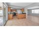 Bright kitchen with wood cabinets, green countertops, and tile floors at 10307 Sandpiper W Rd, Bradenton, FL 34209