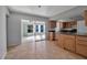 Kitchen with wood cabinets, granite countertops, and access to lanai at 10307 Sandpiper W Rd, Bradenton, FL 34209