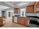Kitchen with wood cabinets, green countertops, and a dishwasher at 10307 Sandpiper W Rd, Bradenton, FL 34209