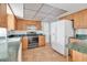 Kitchen features wood cabinets, green countertops, and stainless steel appliances at 10307 Sandpiper W Rd, Bradenton, FL 34209