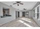 Bright sunroom with light flooring, ceiling fan and views of the backyard at 10307 Sandpiper W Rd, Bradenton, FL 34209