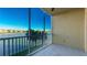 Screened balcony with serene lake views, palm trees and exterior community at 10520 Boardwalk Loop # 202, Lakewood Ranch, FL 34202
