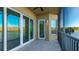 Outdoor balcony with sliding glass doors and lake view at 10520 Boardwalk Loop # 202, Lakewood Ranch, FL 34202