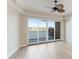 Spacious living area with sliding doors leading to balcony and lake view at 10520 Boardwalk Loop # 202, Lakewood Ranch, FL 34202