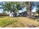 Spacious backyard with mature trees and storage shed at 12302 Tangier St, North Port, FL 34287