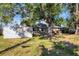Large backyard with mature trees and storage shed at 12302 Tangier St, North Port, FL 34287