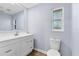 Updated bathroom with white vanity, toilet and a large mirror at 12302 Tangier St, North Port, FL 34287
