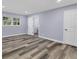 Bright bedroom with wood-look floors and access to bathroom at 12302 Tangier St, North Port, FL 34287