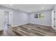 Light and airy bedroom with wood-look floors and large window at 12302 Tangier St, North Port, FL 34287