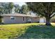 Newly renovated home with a spacious front yard and mature tree at 12302 Tangier St, North Port, FL 34287