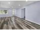 Spacious living room featuring wood-look flooring and light walls at 12302 Tangier St, North Port, FL 34287