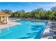 Community pool with plenty of lounge chairs at 12721 20Th E St, Parrish, FL 34219