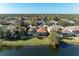 An elevated view showcases a residence with a pool, set against a backdrop of a tranquil lake at 13951 Wood Duck Cir, Lakewood Ranch, FL 34202