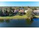 A stunning aerial view of the home with a serene lake and lush greenery, offering a peaceful and private setting at 13951 Wood Duck Cir, Lakewood Ranch, FL 34202