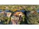 Aerial view of a single-Gathering home with a three-car garage, situated on a waterfront lot at 13951 Wood Duck Cir, Lakewood Ranch, FL 34202