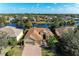 Stunning aerial view of a waterfront home with a three-car garage at 13951 Wood Duck Cir, Lakewood Ranch, FL 34202