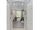 Hallway view of an elegant bathroom with a soaking tub and glass shower at 13951 Wood Duck Cir, Lakewood Ranch, FL 34202