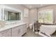 Bright bathroom with a soaking tub, shower, decorative mirror, and double sinks at 13951 Wood Duck Cir, Lakewood Ranch, FL 34202
