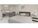 Bedroom featuring a large bed, accent chair, and a window seat at 13951 Wood Duck Cir, Lakewood Ranch, FL 34202