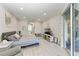 Bedroom with a view to the bathroom, a sliding glass door, and neutral decor at 13951 Wood Duck Cir, Lakewood Ranch, FL 34202