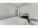 Cozy bedroom with light colored floors, a tv on a stand, and neutral gray walls at 13951 Wood Duck Cir, Lakewood Ranch, FL 34202