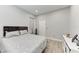 Bright bedroom with light hardwood floors, gray walls, closet, window, and a comfortable queen size bed at 13951 Wood Duck Cir, Lakewood Ranch, FL 34202