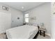 Comfortable bedroom has light hardwood floors, gray walls, closet, window, and a comfortable queen size bed at 13951 Wood Duck Cir, Lakewood Ranch, FL 34202