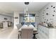 Modern dining area with elegant lighting and a view to the pool at 13951 Wood Duck Cir, Lakewood Ranch, FL 34202