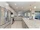 Bright, open kitchen with a large granite island, stainless steel appliances, and grey cabinetry at 13951 Wood Duck Cir, Lakewood Ranch, FL 34202