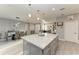 Kitchen featuring a large island, modern pendant lighting, and an open layout to the dining area at 13951 Wood Duck Cir, Lakewood Ranch, FL 34202