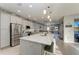 Spacious open kitchen featuring a large island, stainless steel appliances, and grey cabinets at 13951 Wood Duck Cir, Lakewood Ranch, FL 34202
