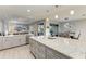 Spacious kitchen featuring a granite island, stainless steel appliances, and modern lighting fixtures at 13951 Wood Duck Cir, Lakewood Ranch, FL 34202