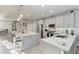 Bright, open kitchen featuring a granite island, stainless steel appliances, and a sink at 13951 Wood Duck Cir, Lakewood Ranch, FL 34202