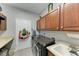 The laundry room features a modern washer and dryer, storage cabinets, a sink, and neutral paint at 13951 Wood Duck Cir, Lakewood Ranch, FL 34202